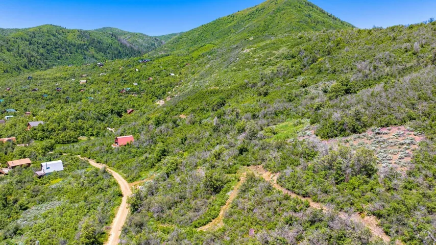 Expansive mountainous terrain featuring dense natural foliage and varying elevations