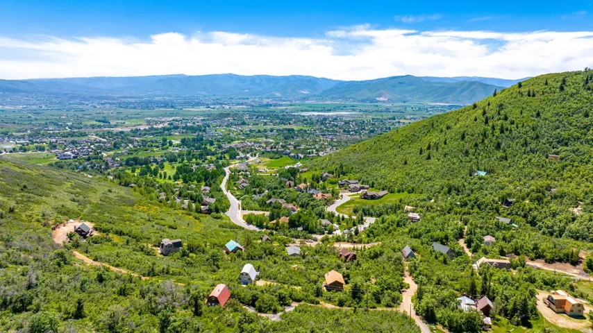 Expansive mountain landscape featuring varied elevations and extensive natural greenery