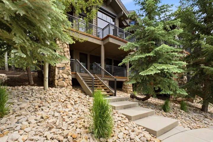 Multi-level exterior featuring stone accents and dark wood siding