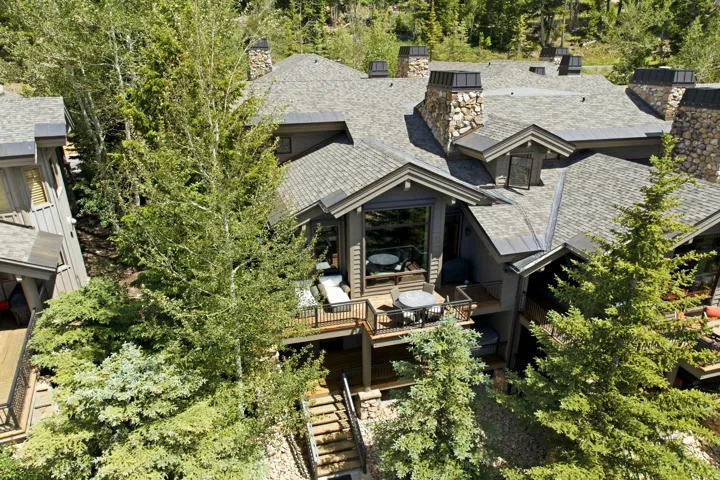 Multi-level property featuring a stone and wood exterior
