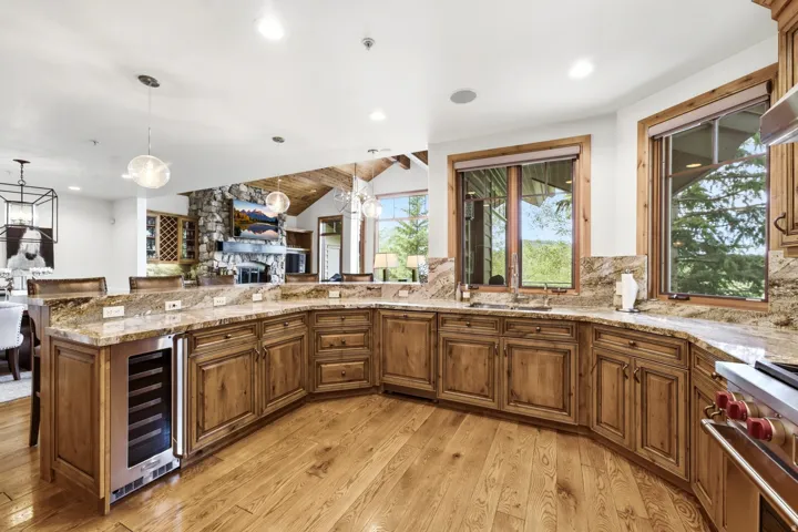 Spacious kitchen featuring wood-finish cabinetry, light-toned countertops, and wood-finish flooring