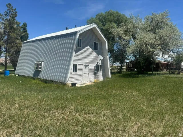 A-frame style residence featuring horizontal siding and a corrugated metal roof