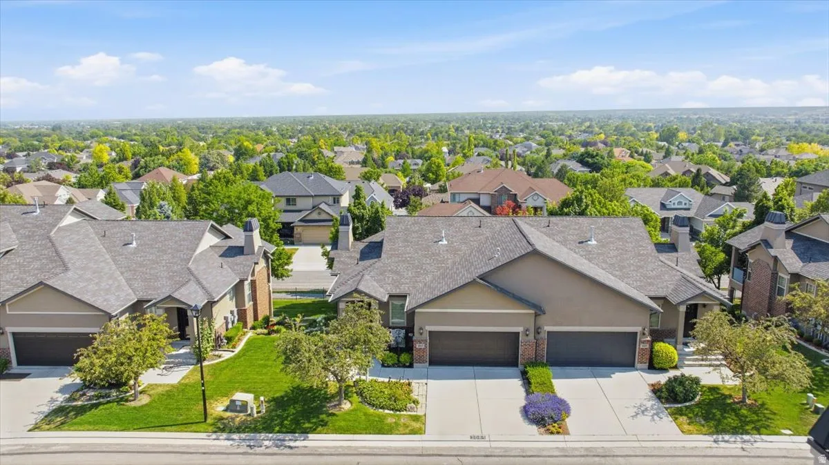 Contemporary multi-unit property with a neutral-toned exterior and dark roofing