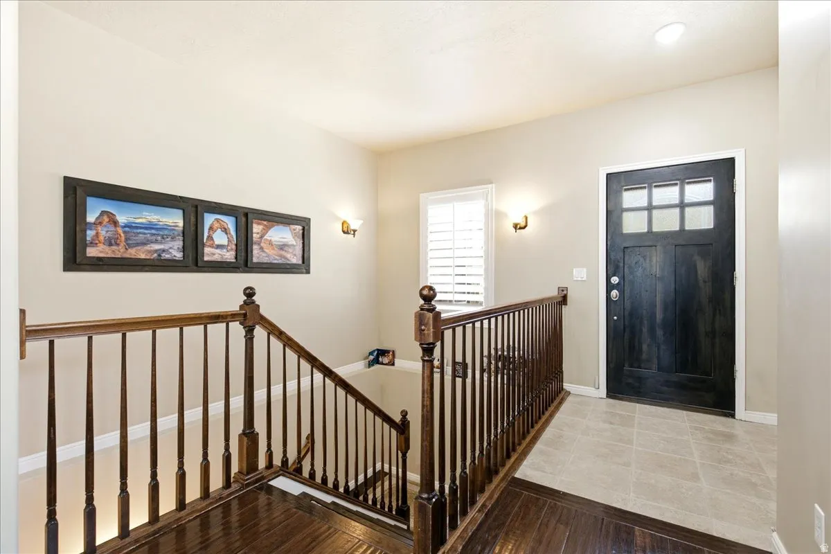 Foyer with a dark wood-finish entry door featuring upper glass panels and white trim