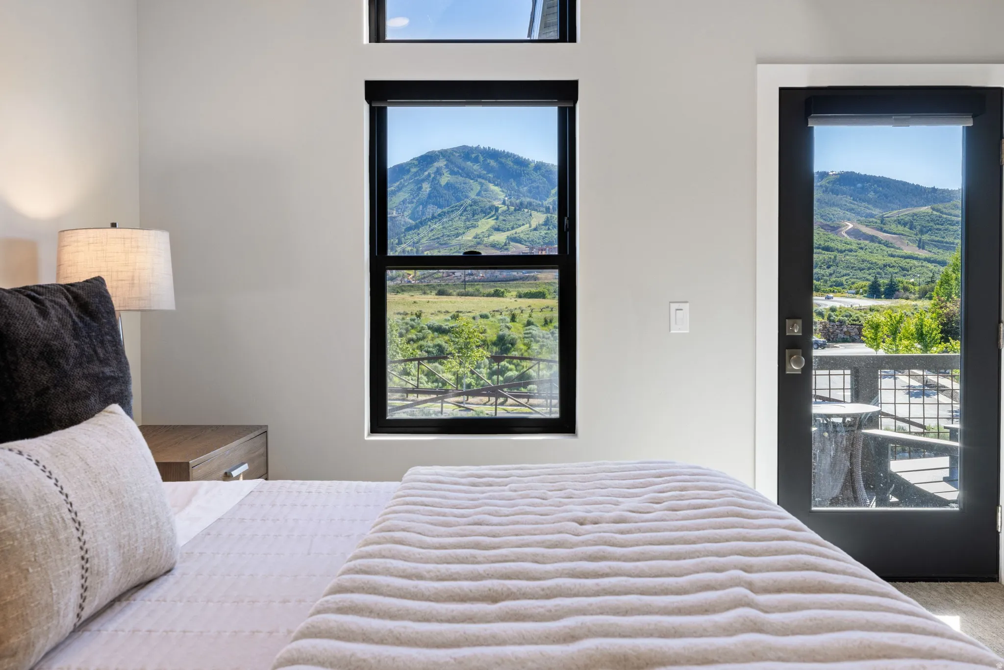 Floor-to-ceiling windows and a full-light door offer abundant natural light