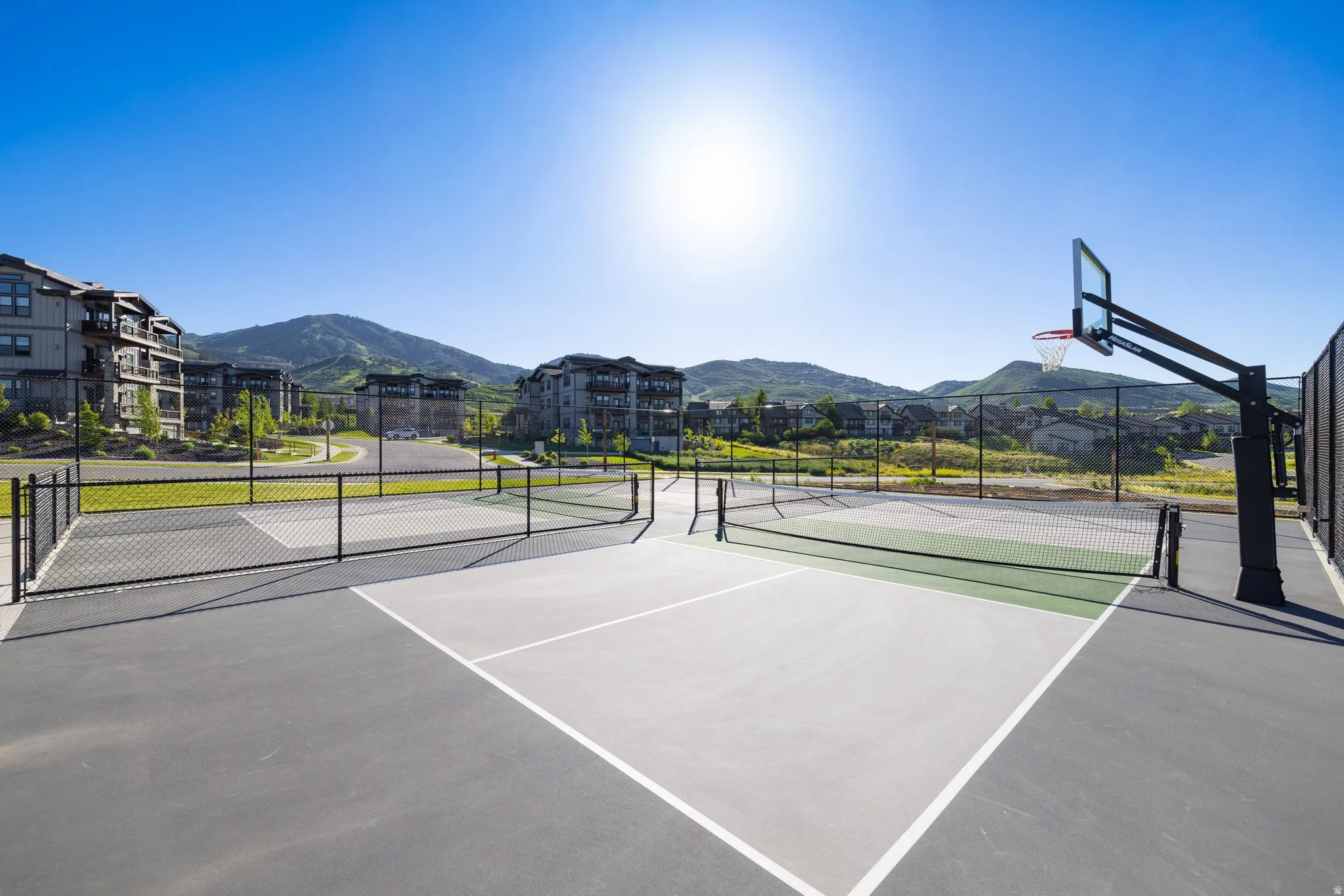 Multi-sport court featuring dedicated lines for pickleball and basketball hoop