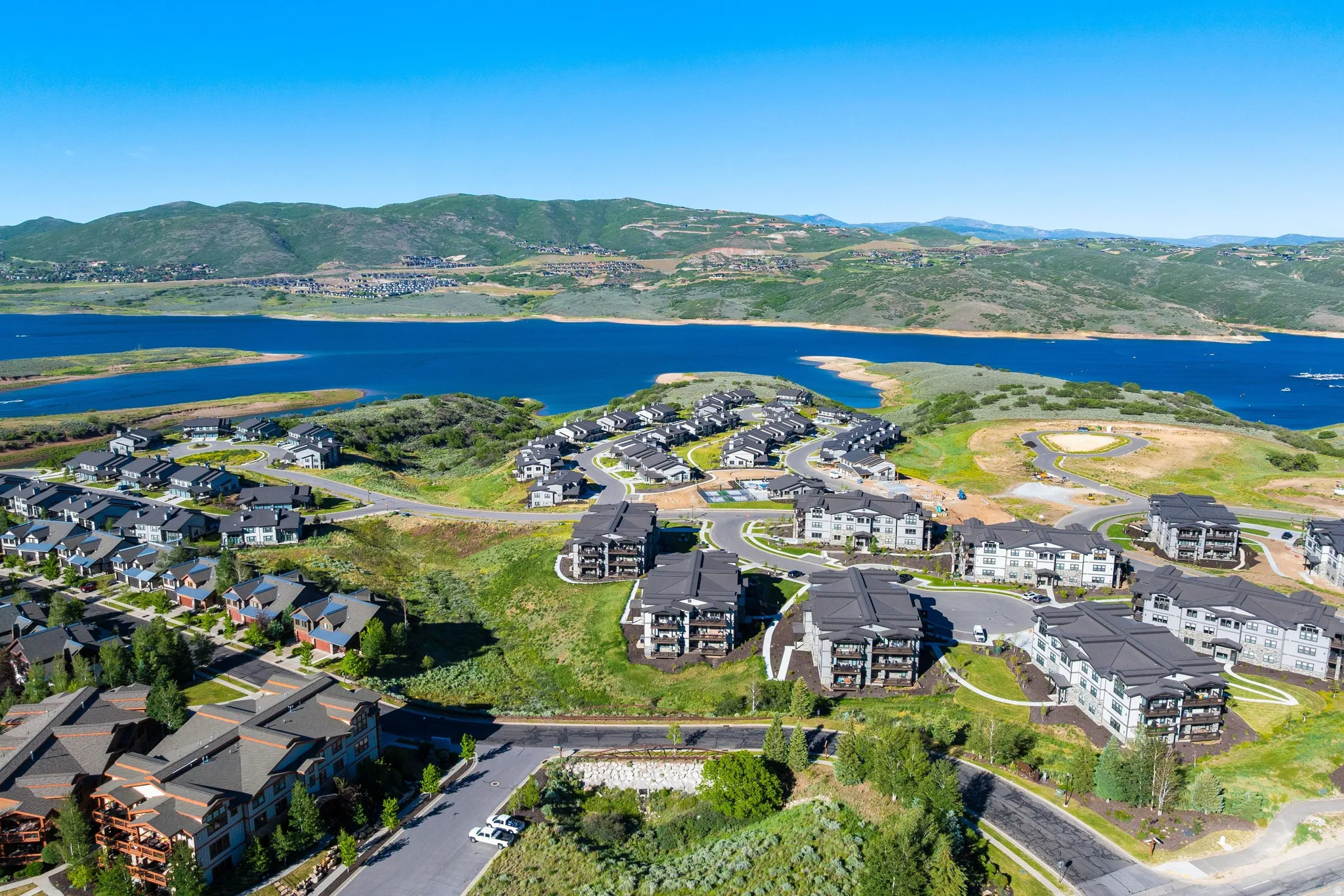 Aerial perspective showcasing a residential community with single-family homes and multi-story buildings