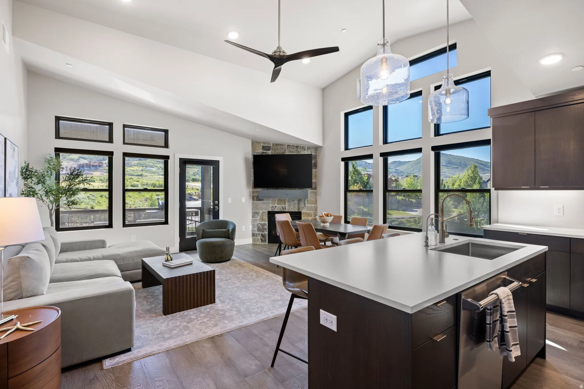 Open-concept living area featuring a vaulted ceiling and dark wood-finish flooring