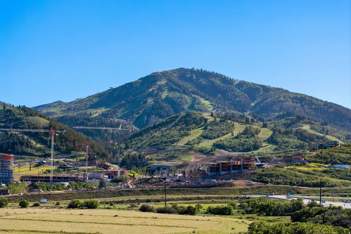 Expansive mountain terrain with visible ski slopes and verdant forests