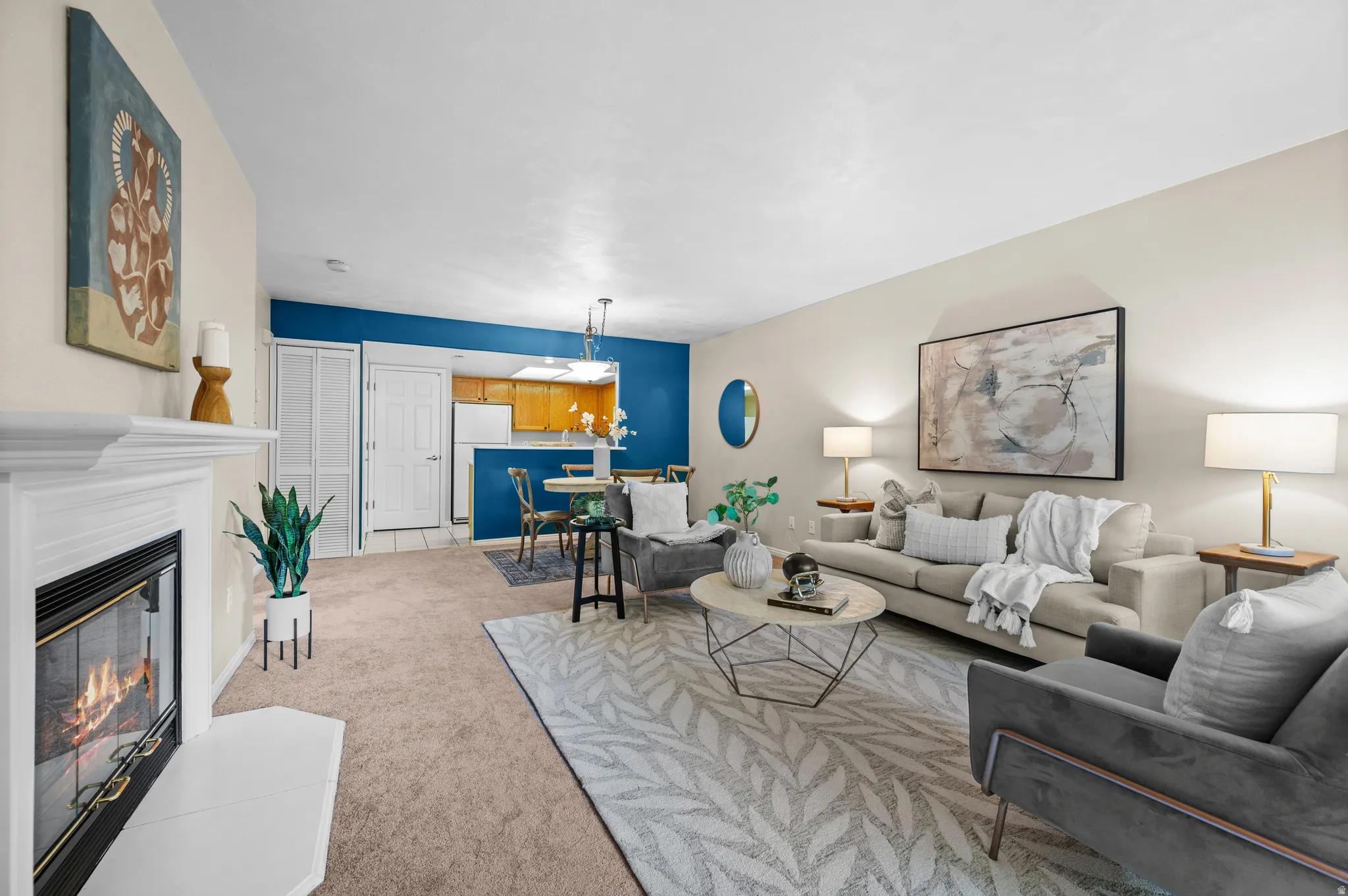 Living room featuring a classic white fireplace, carpeting, and light-toned walls
