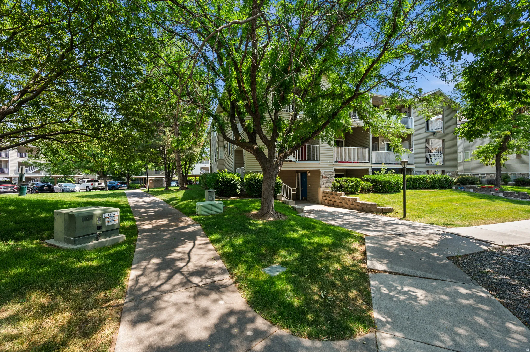 Manicured green spaces with mature trees and concrete pathways