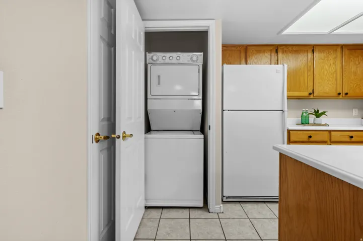 Kitchen area featuring wood cabinetry, white countertops, and tile flooring