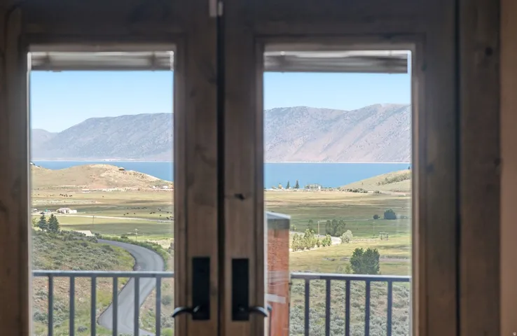 Double French doors opening to an exterior balcony with metal railings