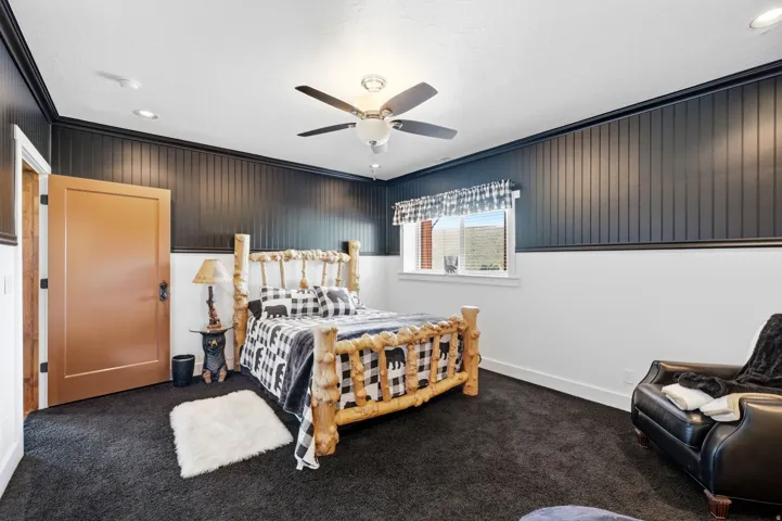 Room featuring dark carpet flooring and a ceiling fan with integrated lighting