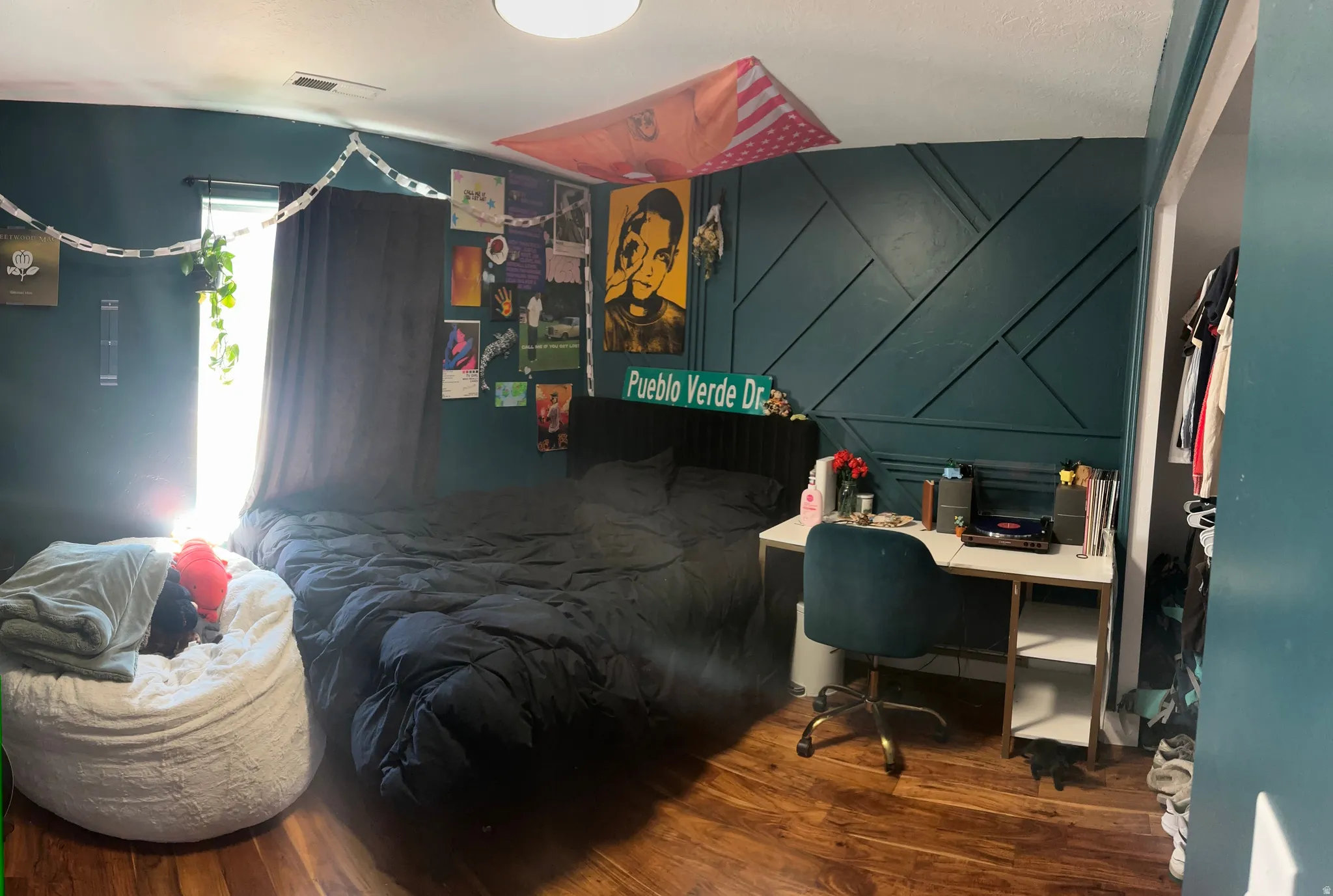 3rd bedroom featuring a decorative accent wall with geometric paneling