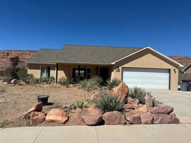 Single-story residence featuring porch and xeriscaped front yard