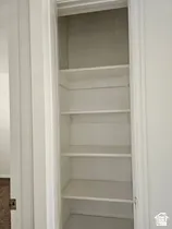 Built-in shelving unit with multiple white-painted shelves