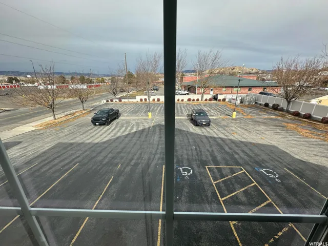 Expansive asphalt parking lot featuring painted parking stripes and designated accessible parking