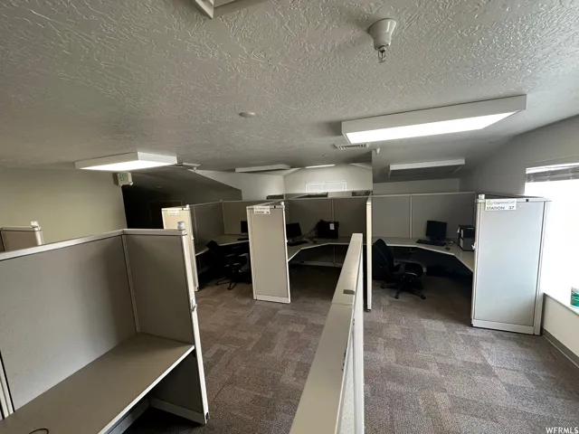 Office interior featuring multiple cubicle workstations