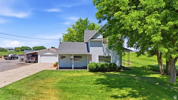 Light blue siding exterior with dark shingled roof