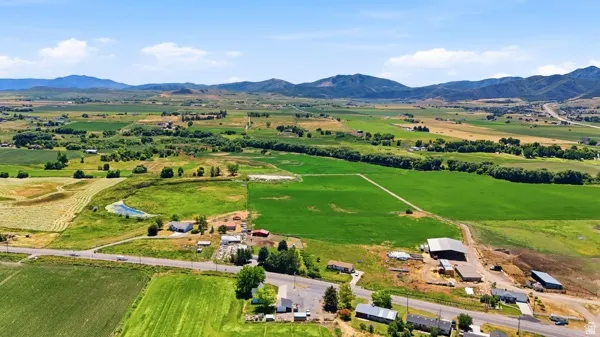 Extensive agricultural land with multiple structures under a clear sky