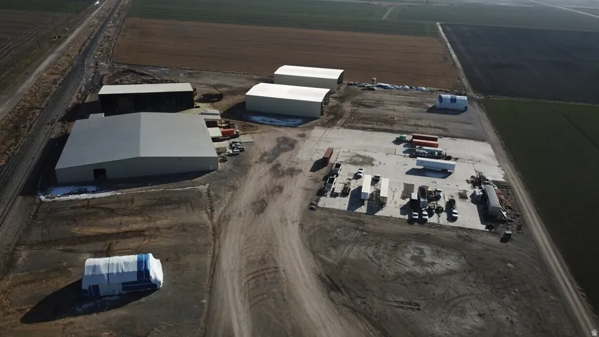 Expansive commercial property featuring multiple metal warehouse structures with light-colored roofs