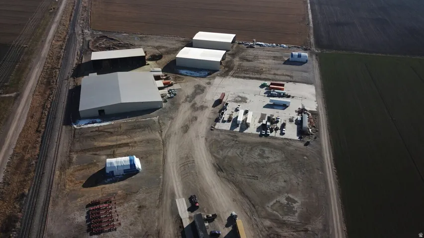 Expansive property featuring multiple industrial buildings with light-colored roofing