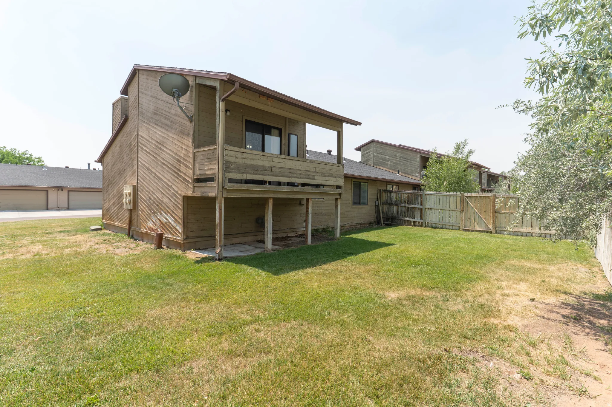 Expansive grass backyard with wood privacy fencing