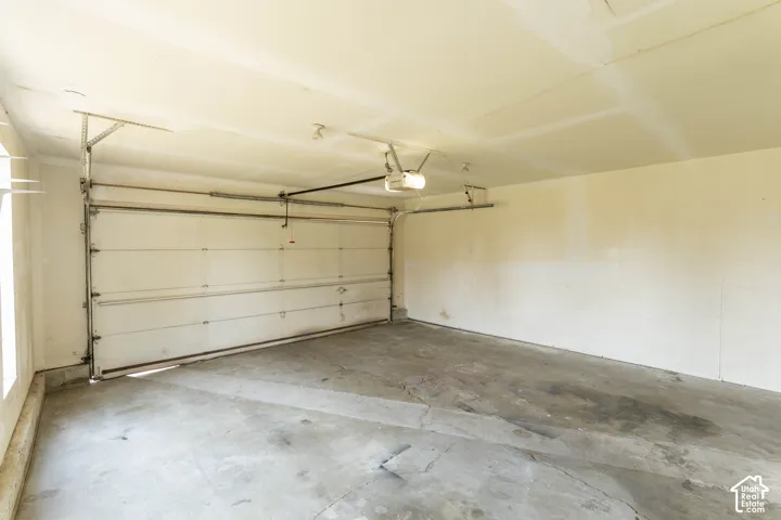 Spacious garage with a sectional overhead door and an automatic opener system