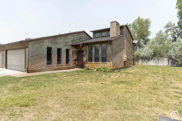 Multi-level exterior featuring wood paneling and stone accents