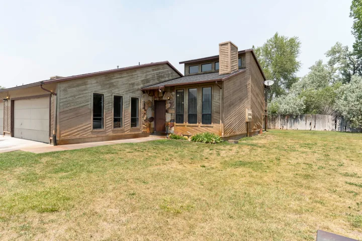 Multi-level exterior featuring wood paneling and stone accents