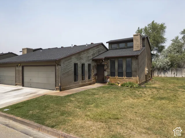 Wood-clad exterior featuring a stone accent wall and multiple vertical windows