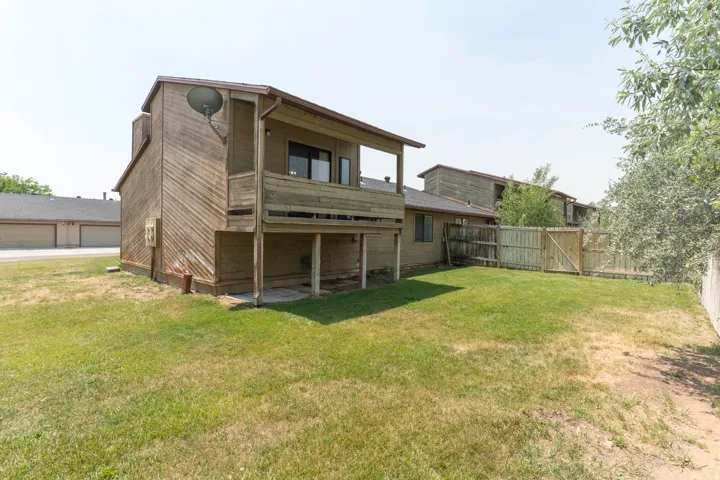 Expansive grass backyard with wood privacy fencing