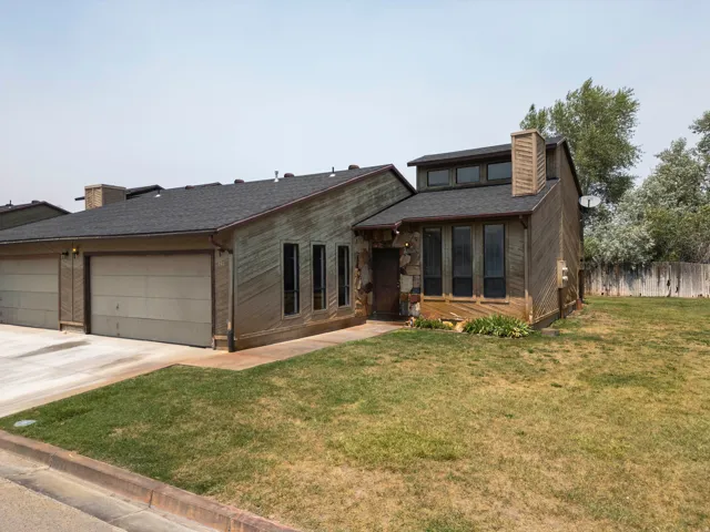 Wood-clad exterior featuring a stone accent wall and multiple vertical windows