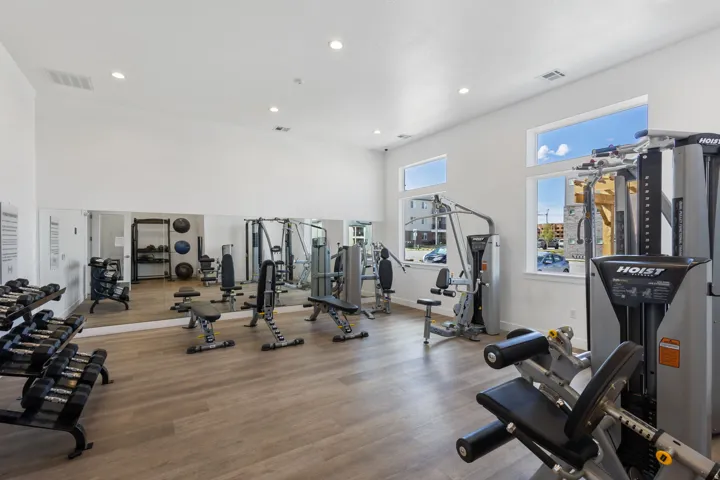 Fitness center featuring wood-finish flooring, recessed lighting, and multiple windows