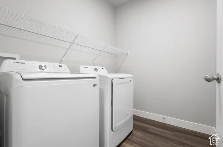 Dedicated laundry area featuring a white wire shelving unit, wood-finish flooring, and a neutral wall color