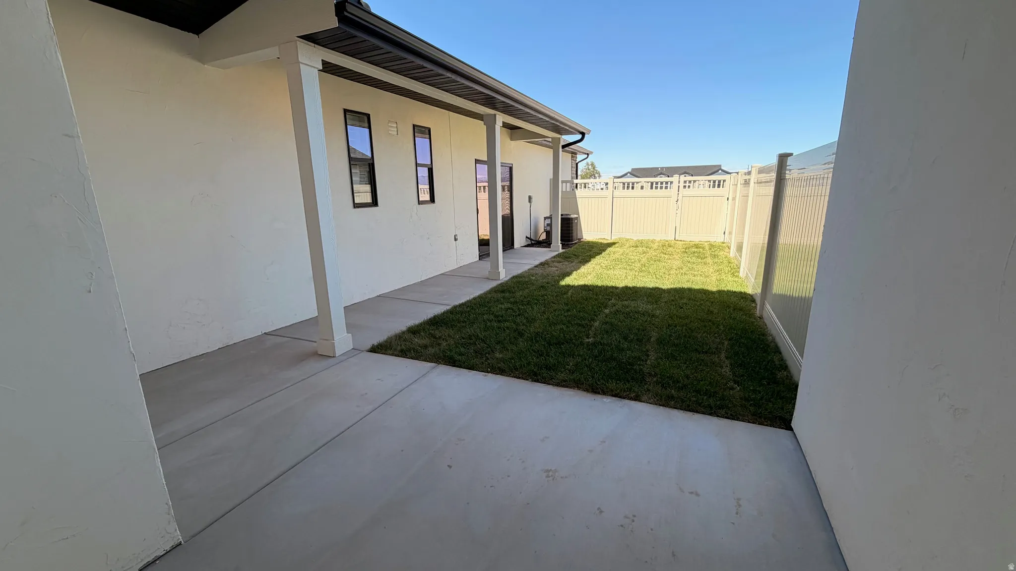 Private backyard space featuring a new sod lawn and full privacy fencing