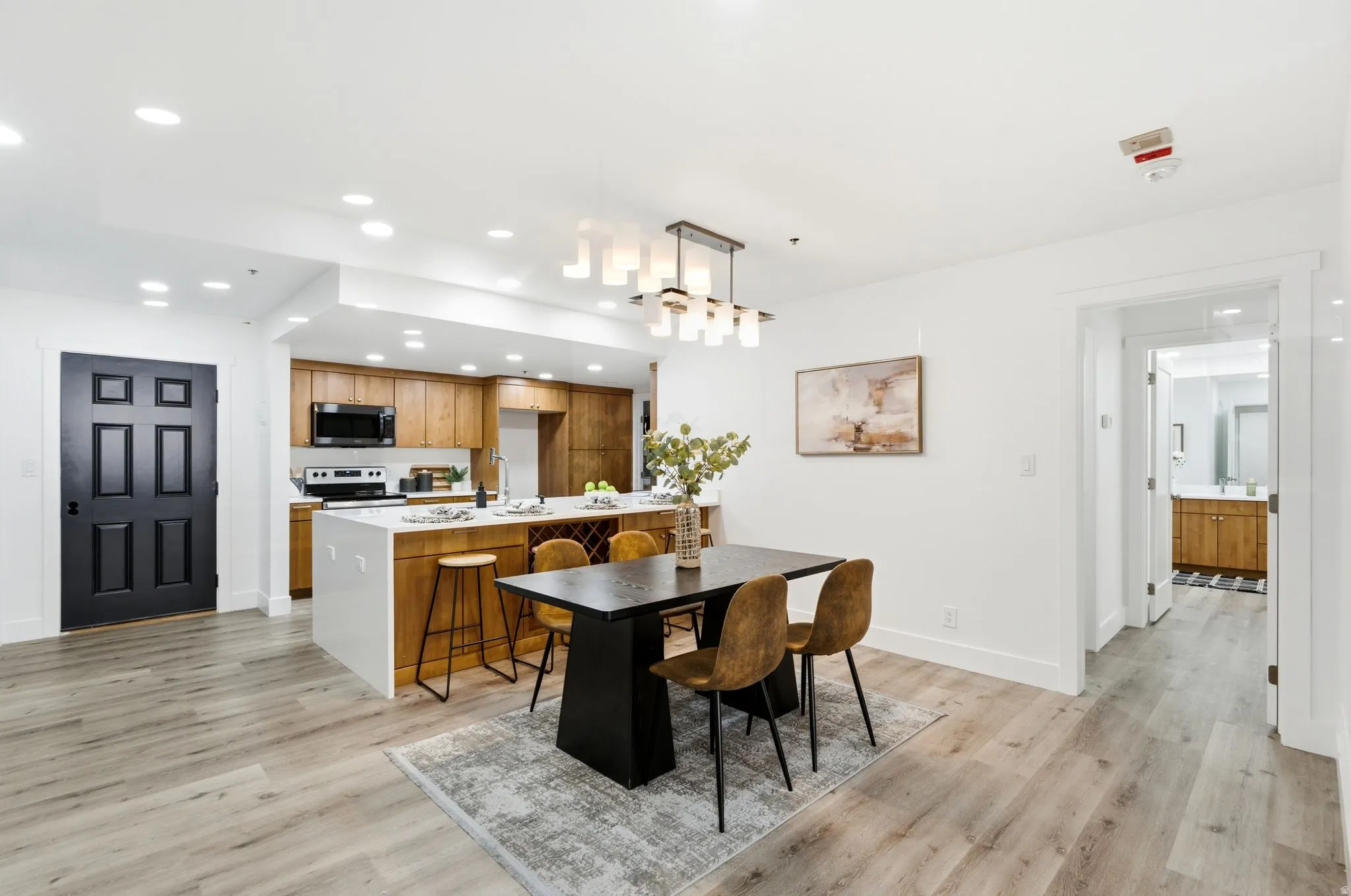 Modern open-concept living space with wood-finish flooring throughout