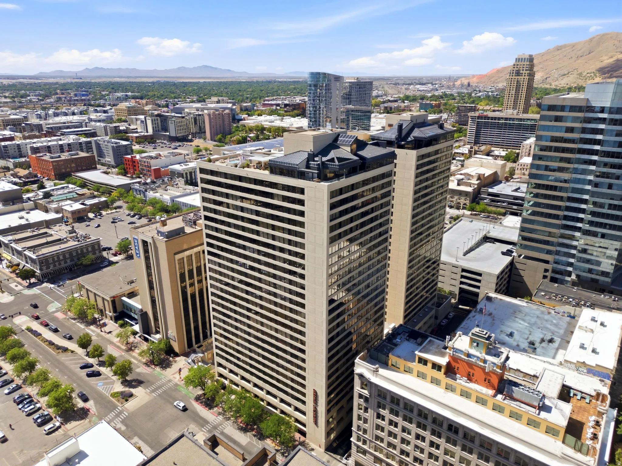 American Towers High-rise buildings featuring a multi-story facade with numerous windows, a flat roofline, and visible rooftop structures