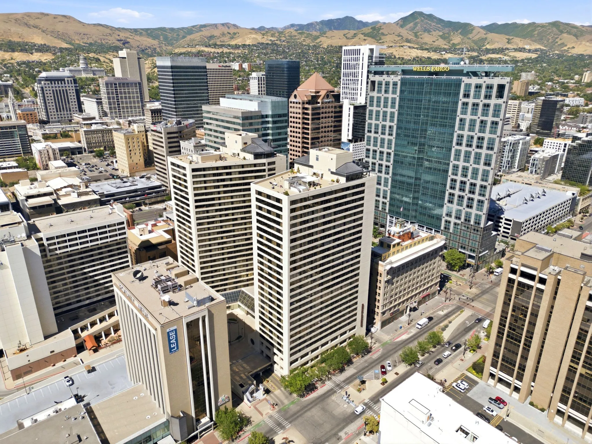 Urban skyline featuring American Towers South Tower and numerous high-rise buildings and surrounding mountainous terrain