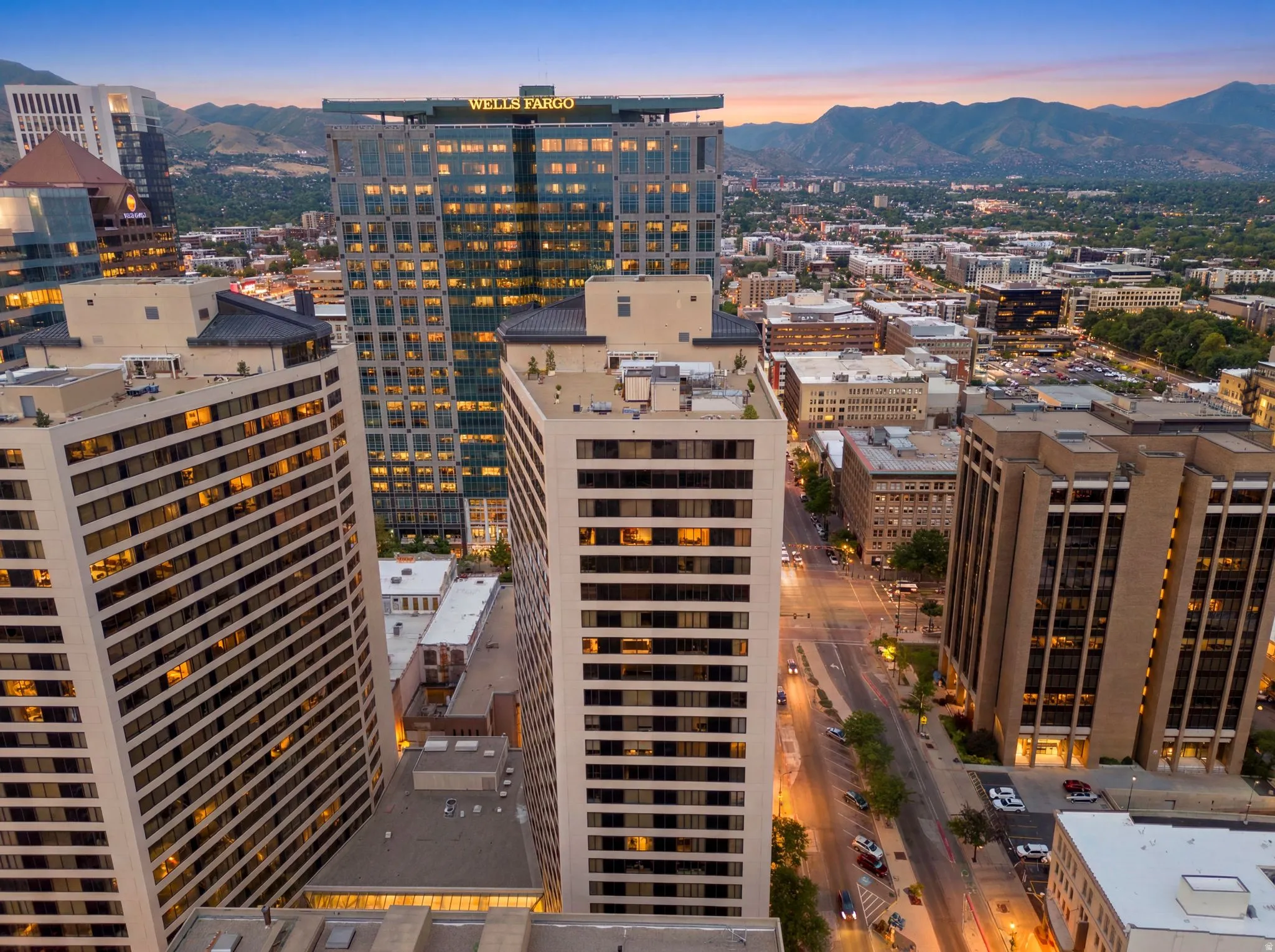 Twilight view of American Towers Urban skyline featuring multiple high-rise buildings and distant mountains