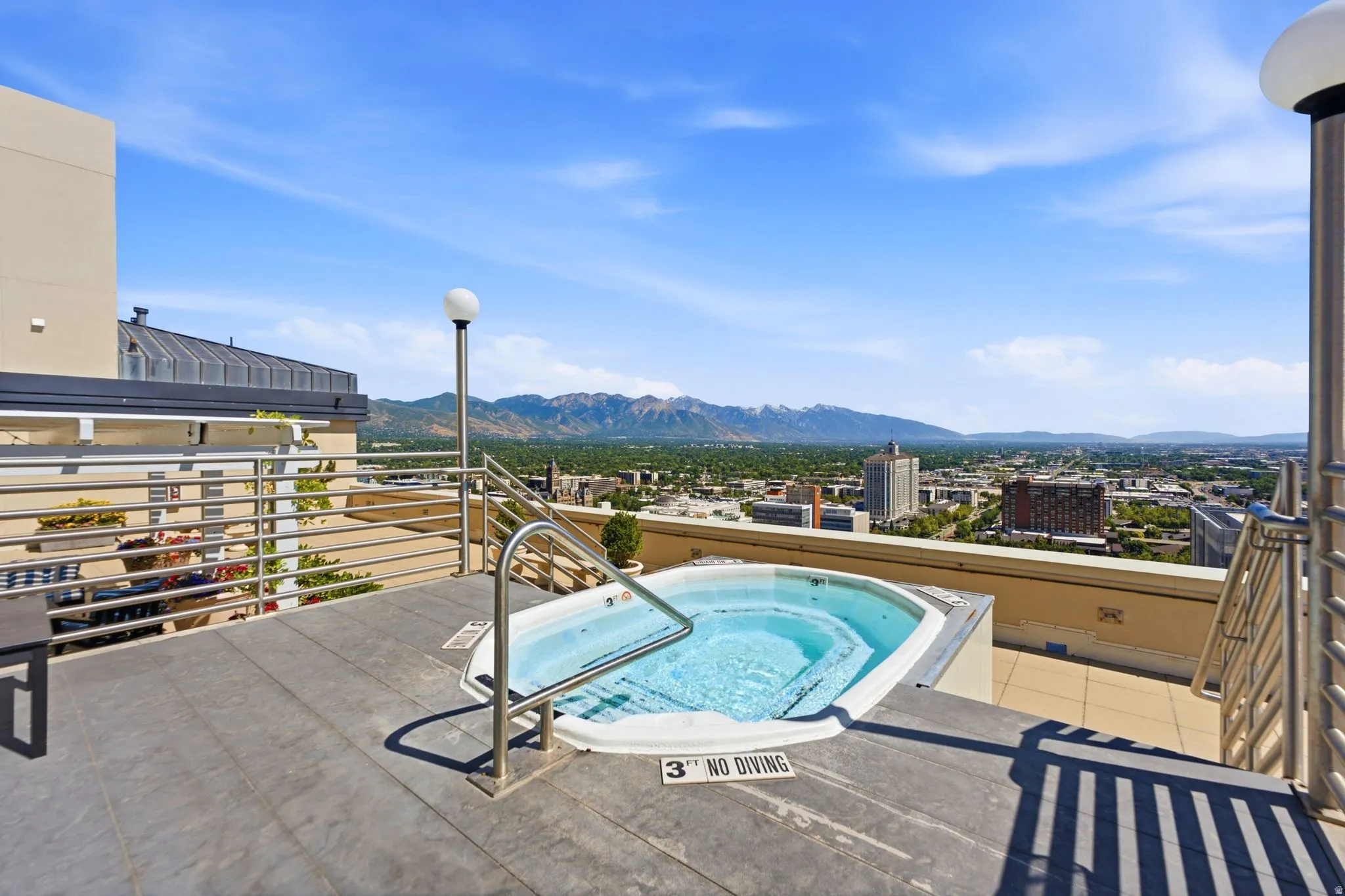 Rooftop patio with an integrated spa, complete with stainless steel handrails