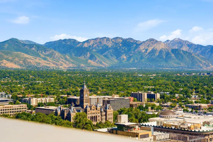 Expansive east mountains view from the rooftop and backdrop framing a verdant urban landscape