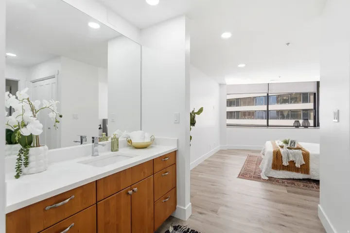 Master Bathroom vanity featuring a light wood-finish cabinet with silver hardware, an integrated white rectangular sink, and a white countertop