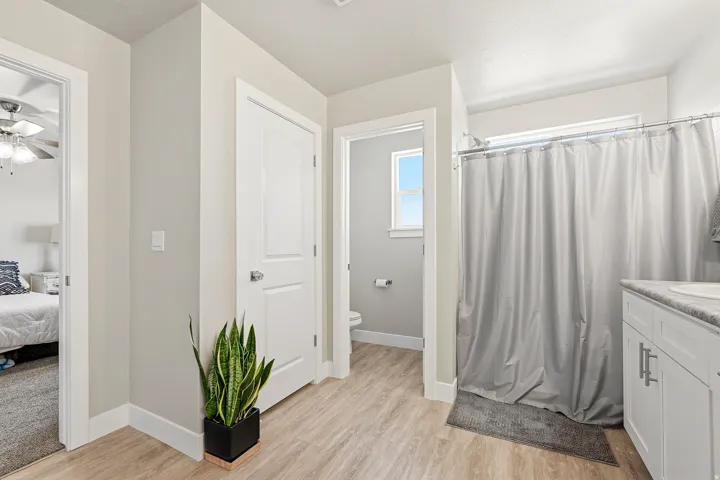 Bathroom vanity with white cabinetry, silver-tone hardware, and a light-toned countertop