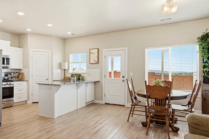 Modern kitchen and dining area with wood-finish flooring