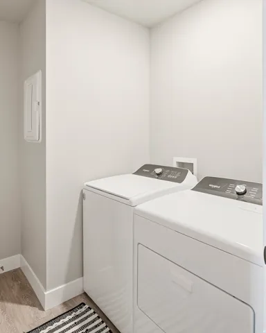 Dedicated laundry area featuring a white top-load washing machine and front-load dryer