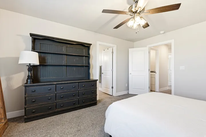 Carpeted room featuring a ceiling fan with light fixture, recessed lighting, and white baseboards