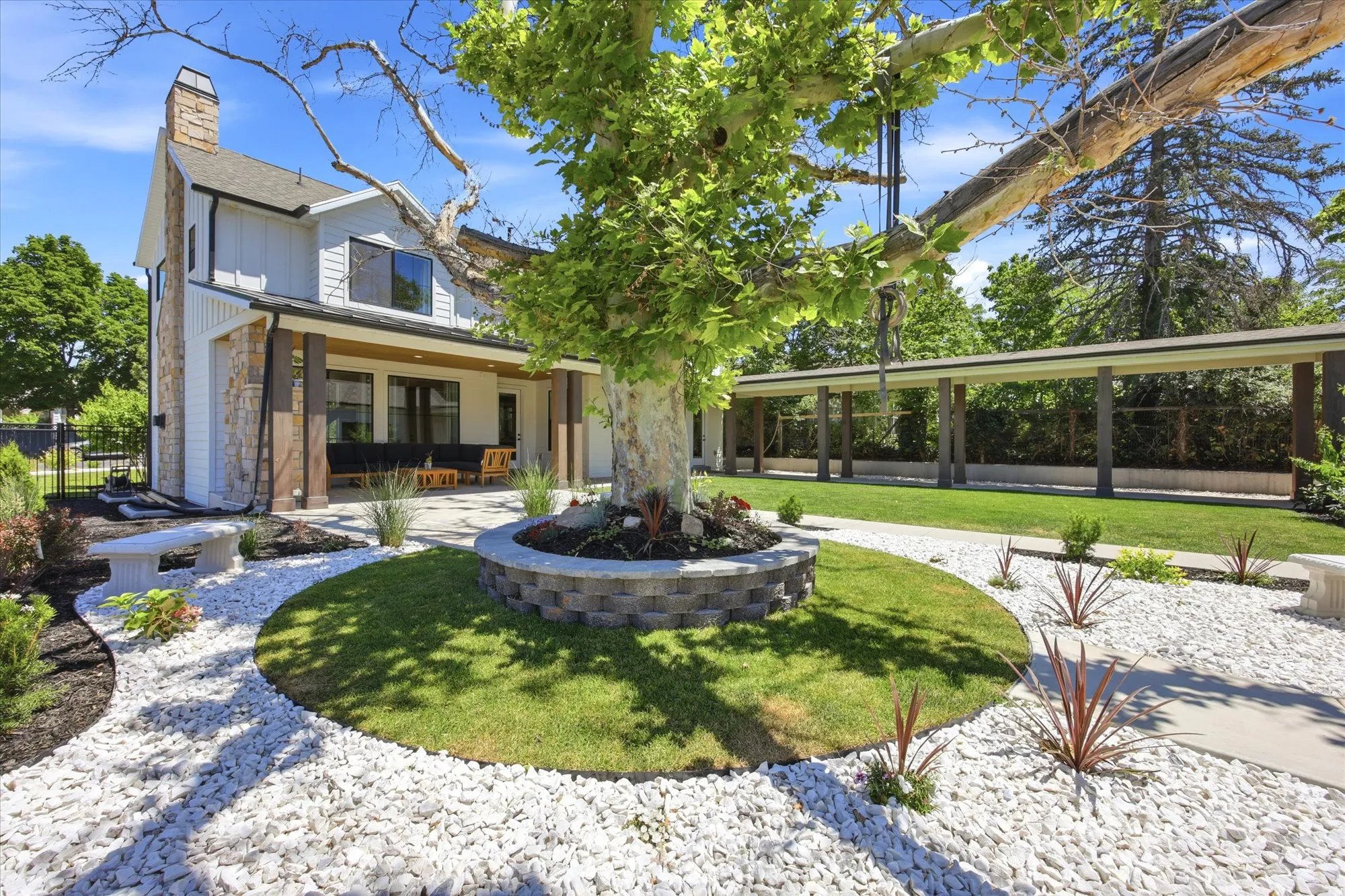 Landscaped exterior featuring white siding and stone accents