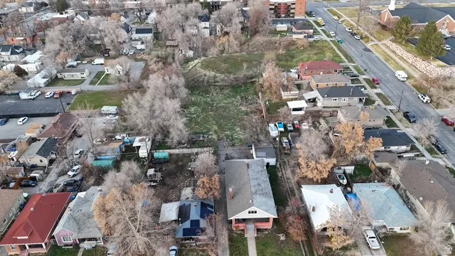 Expansive land parcel featuring existing residential structures and extensive undeveloped terrain